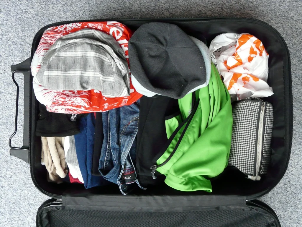 Open suitcase filled with clothes